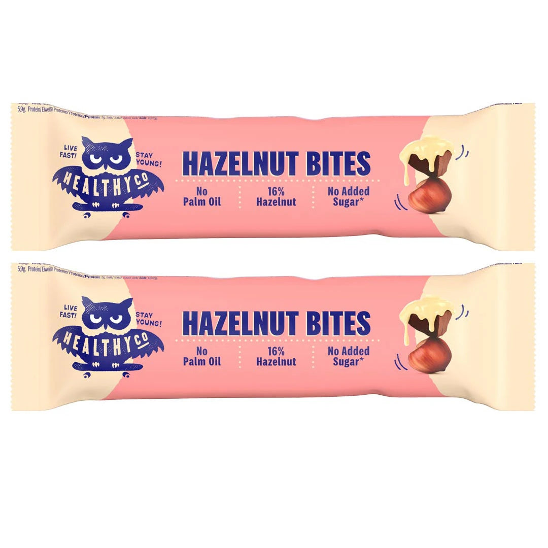 Healthyco Hazelnut Bites 21 g x 2 st i två rosa förpackningar med mörkblå text och en illustrerad hasselnöt.