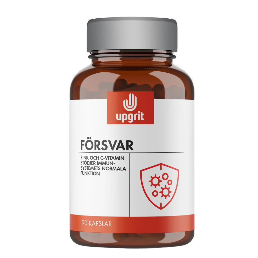Upgrit Försvar 90 caps kosttillskott i en mörk glasburk med vit etikett och silvrigt lock.