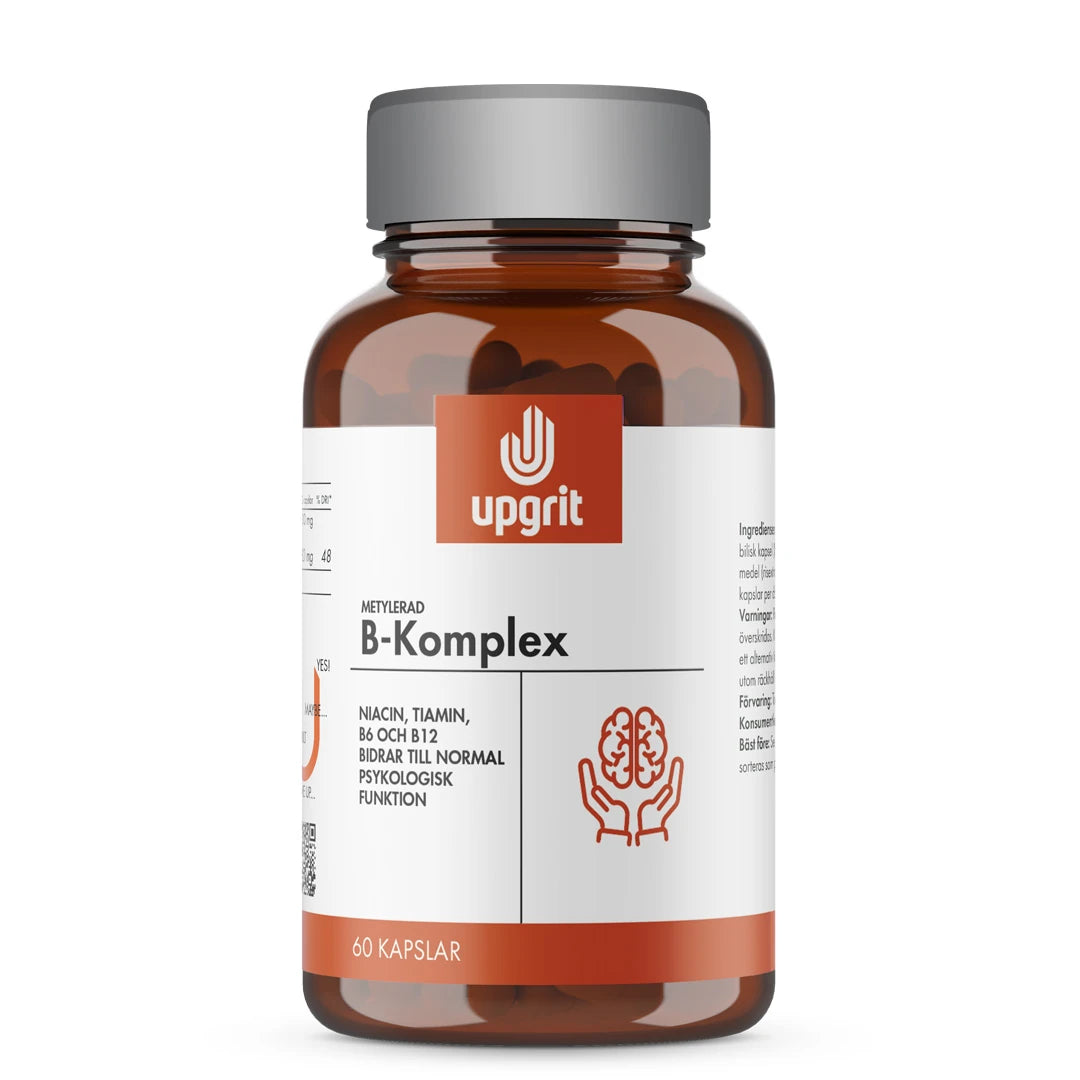 Upgrit B-Komplex 60 kapslar i en mörkbrun burk med silverlock och vit etikett med orange detaljer.