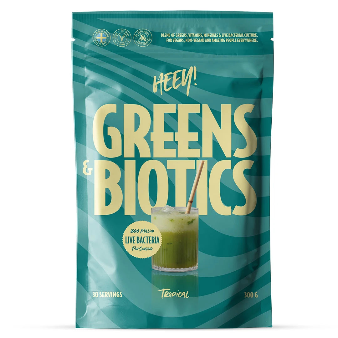 Heey! Greens & Biotics Superfood + Probiotics 300 g i en blågrön påse för smaken Tropical.