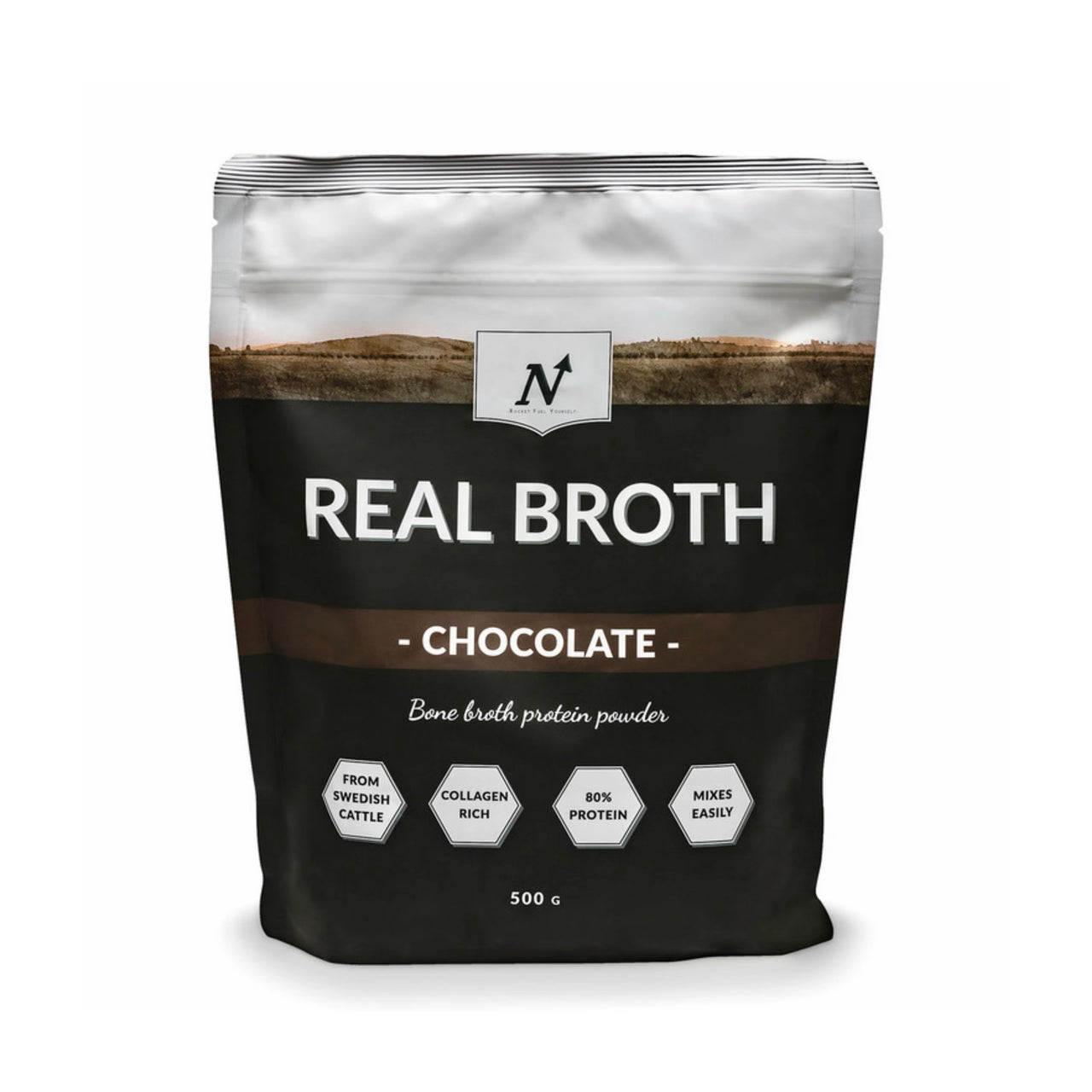 Nyttoteket Real Broth 500 g benbuljongspulver i en svart och vit påse med bruna detaljer för smaken Chocolate.
