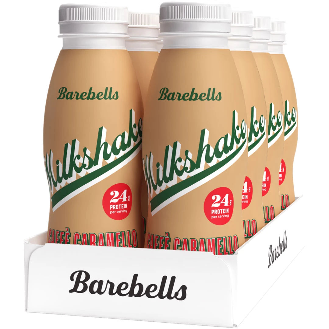 8 x Barebells Milkshake 330 ml Caffé Caramello i ett vitt tråg med ljusbruna flaskor och gröna detaljer.