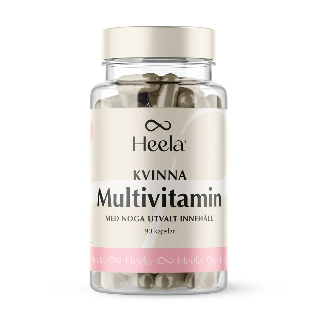 Heela Multivitamin Woman 60 caps i en genomskinlig burk med ljust lock och en beige etikett med rosa detaljer.