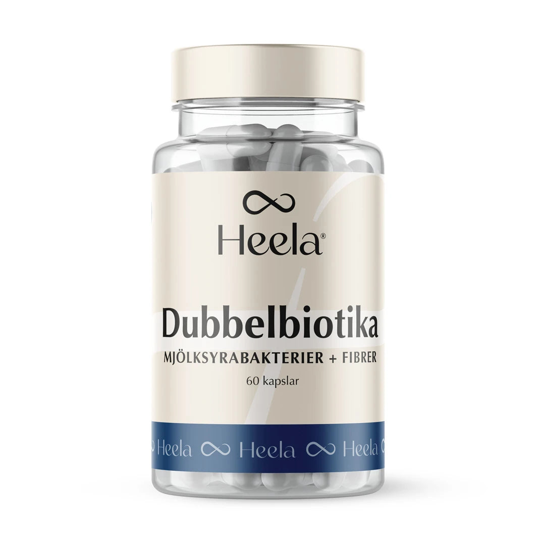 Heela Dubbelbiotika 60 caps i en genomskinlig burk med beige etikett, blåa detaljer och vita kapslar inuti.