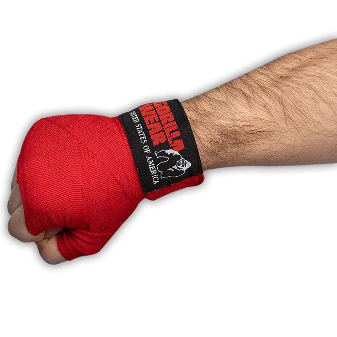 Gorilla Wear Boxing Hand Wraps Red, röda boxningslindor runt en knuten hand med märkets svarta logga på handleden.