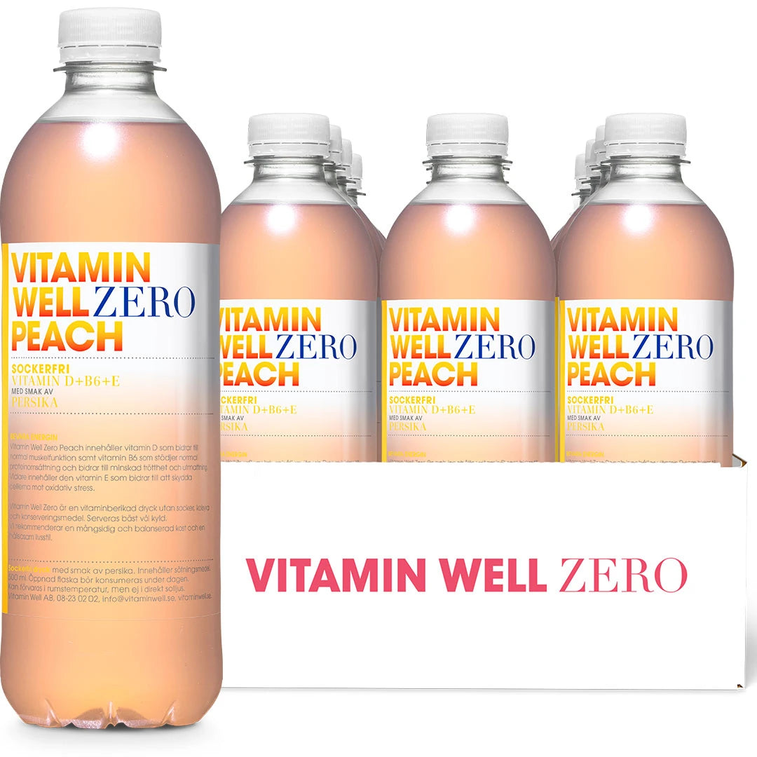 12 x Vitamin Well Zero 500 ml Peach i ett vitt flak med transparenta flaskor fyllda med ljusrosa dryck.