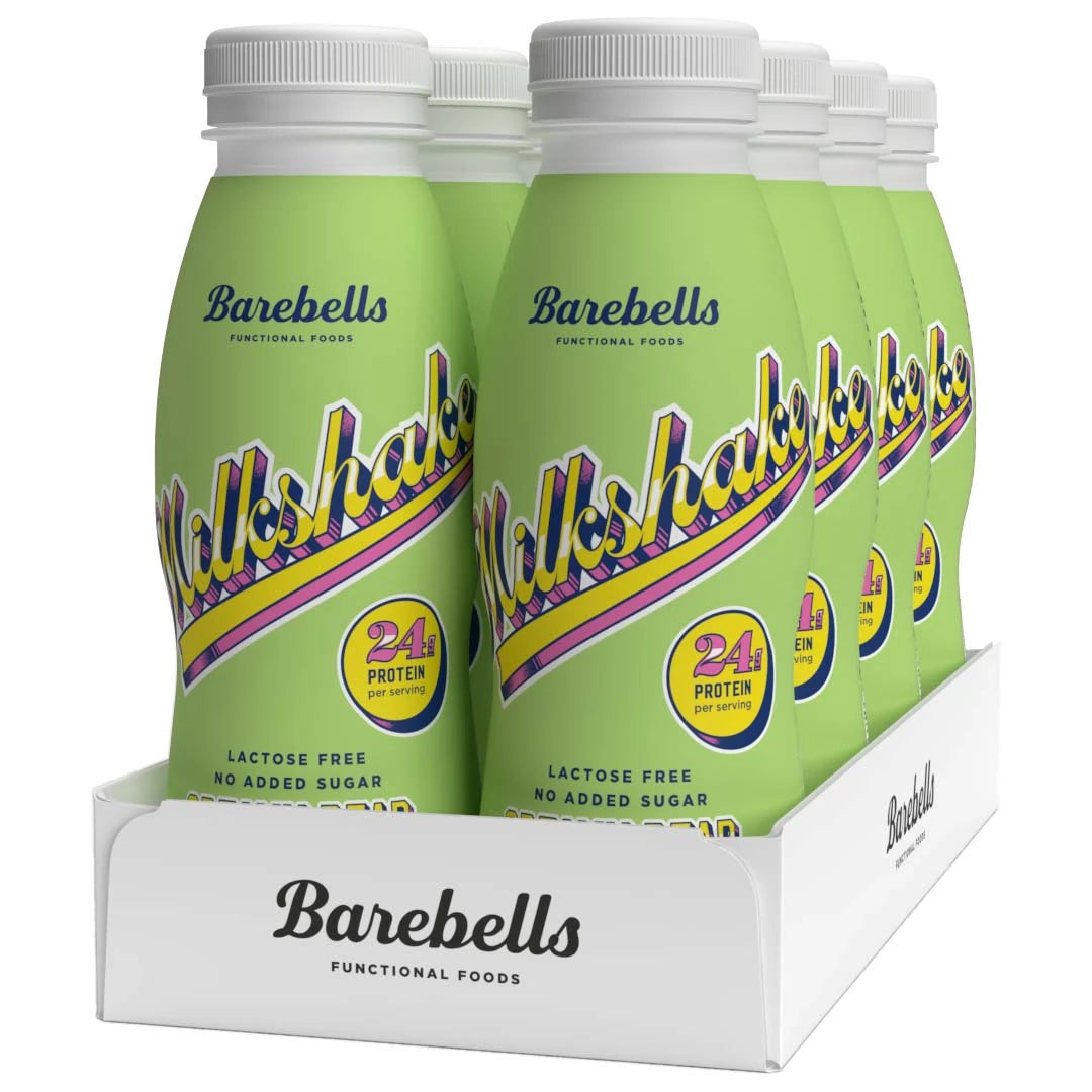 8 x Barebells Milkshake 330 ml Creamy Pear i en vit kartong med ljusgröna flaskor och retroinspirerad text.