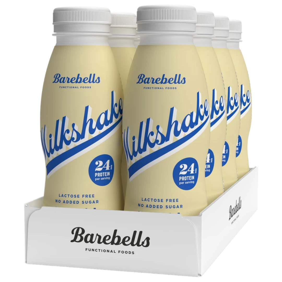 8 x Barebells Milkshake 330 ml Vanilla i ljusgula flaskor med blå text i en vit kartong.