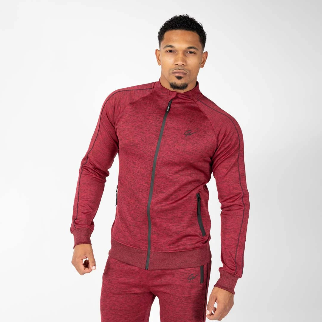 Gorilla Wear Wenden Track Jacket Burgundy Red, en mörkröd träningsjacka med svarta detaljer buren av en modell., bild 8 av 8