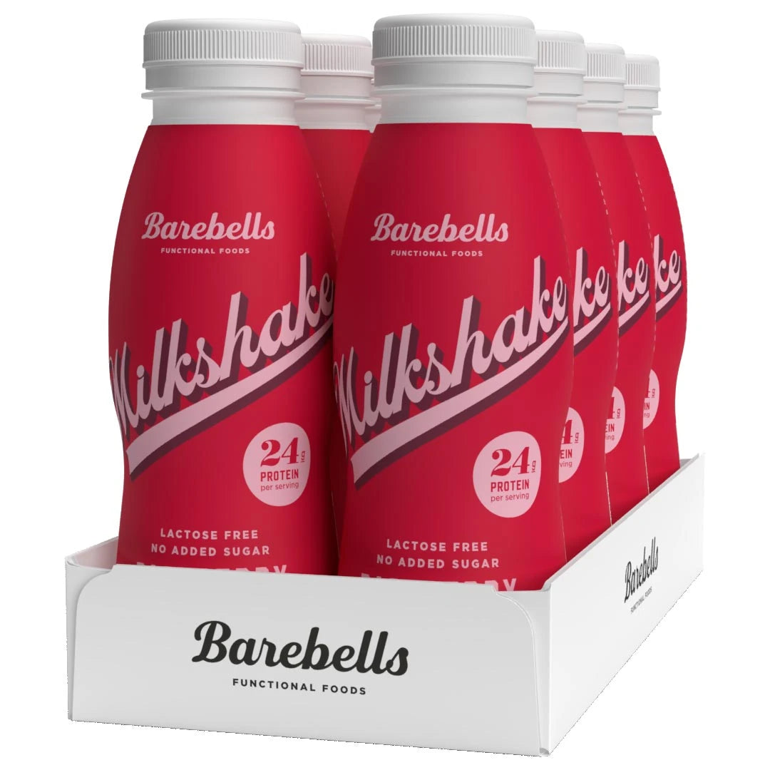 8 x Barebells Milkshake 330 ml Raspberry i ett vitt flak med åtta röda flaskor för smaken hallon.
