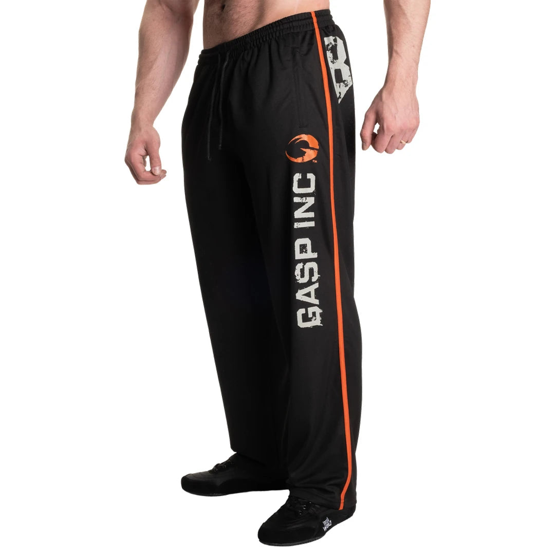 Gasp No 89 Mesh Pants Black är svarta träningsbyxor i mesh med en orange sidorand och ett stort logotryck.