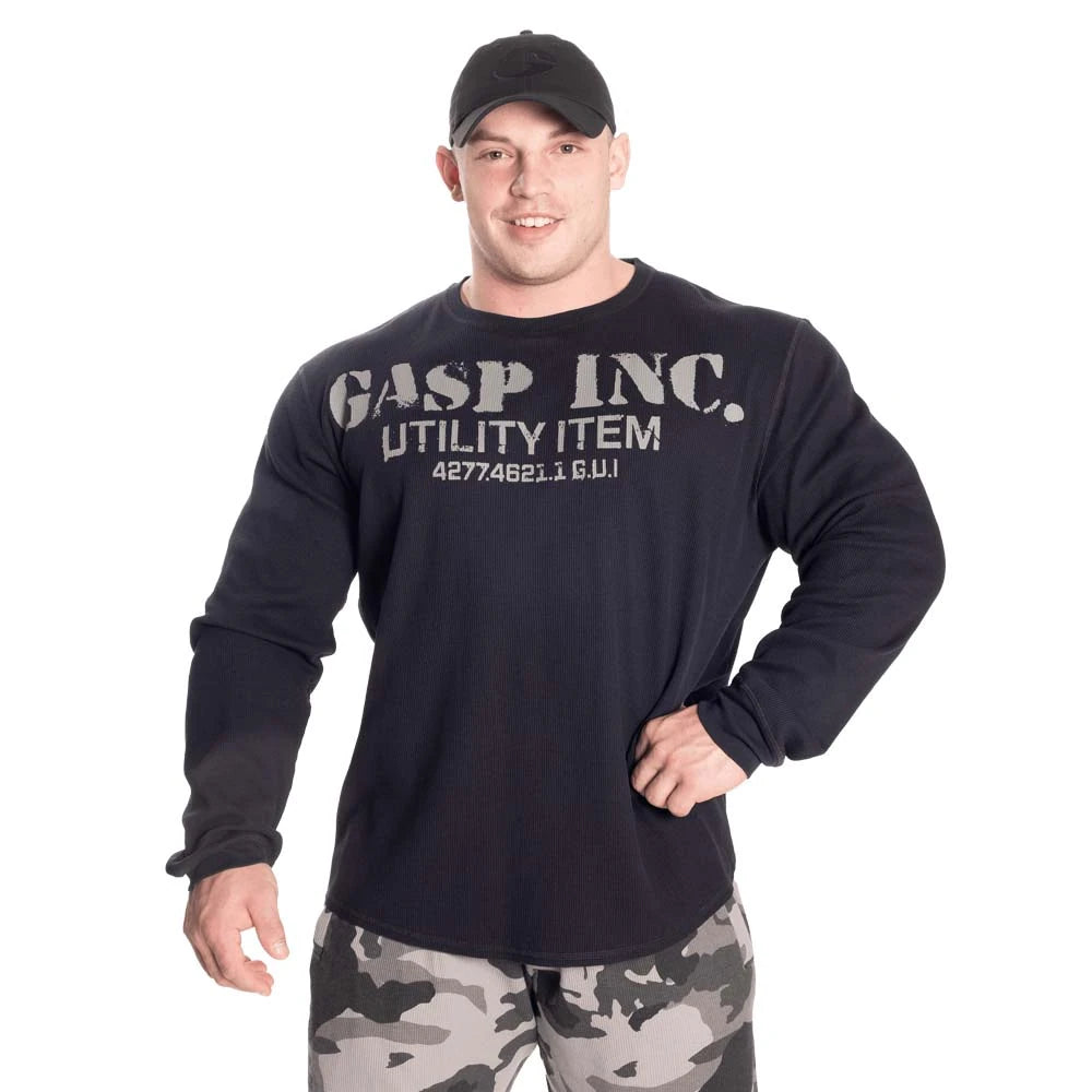 GASP Thermal Gym Sweater Asphalt, en mörk långärmad träningströja i termiskt tyg med stort tryck buren av en man., bild 4 av 6